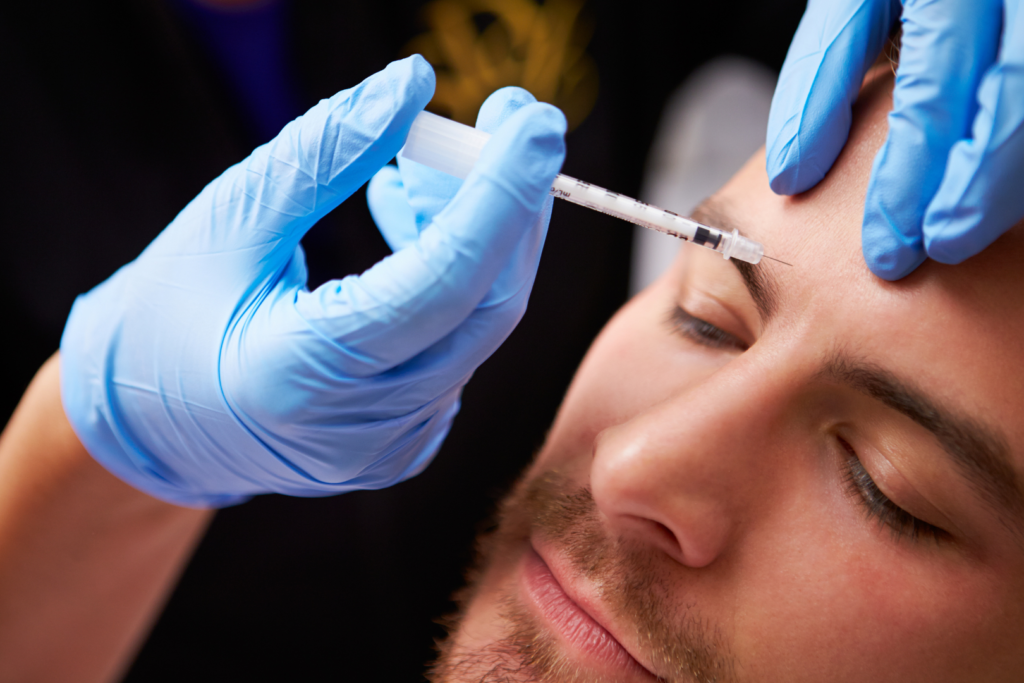 Male getting injected with botox in his forehead